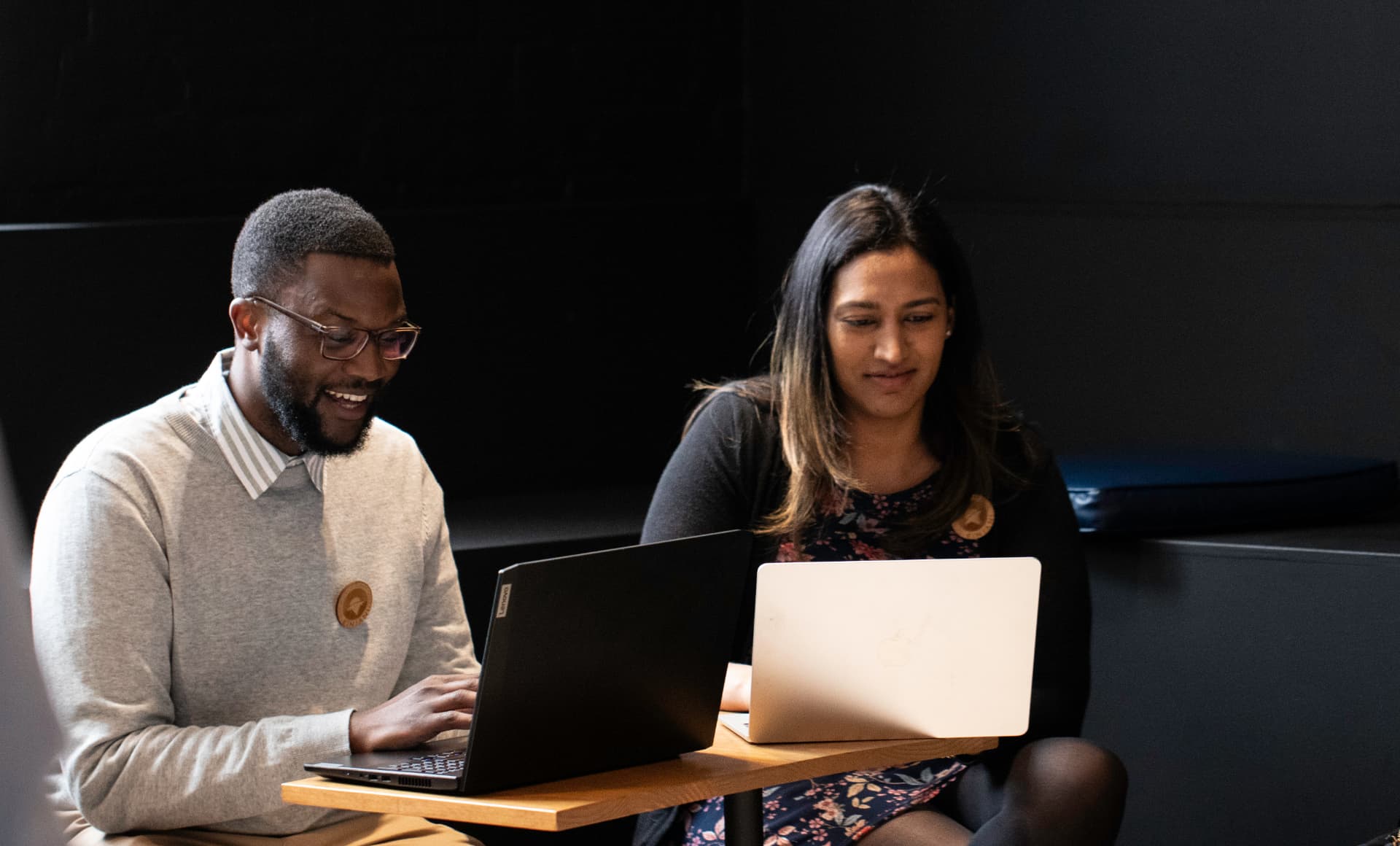Two founders working together on laptops