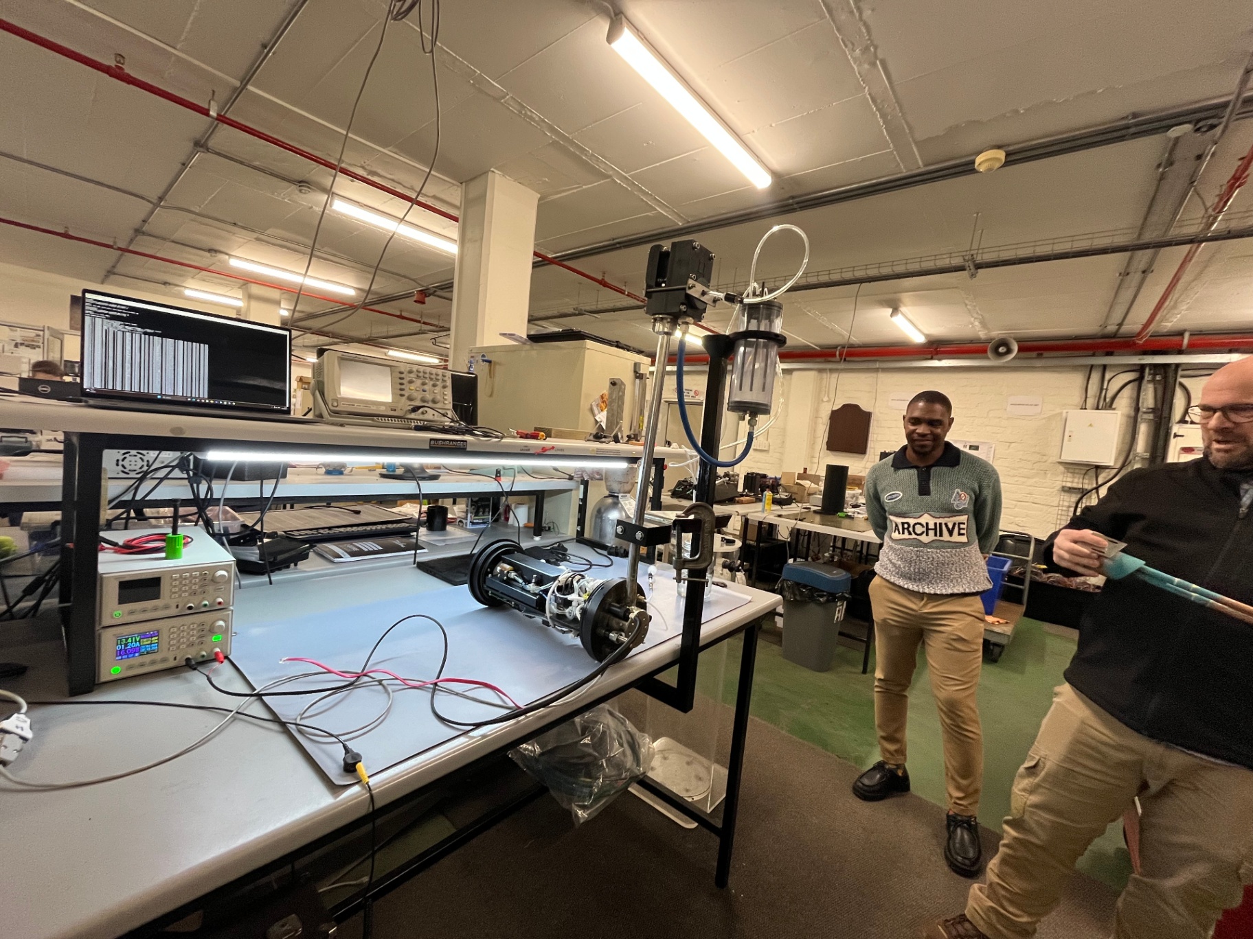Researchers inspecting scientific equipment in a laboratory